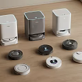 Various Robotic Vacuums With Different Colored Charging Stations On Wooden Floor