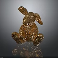 Decorative Golden Rabbit Figurine Sitting With Textured Metallic Surface On Black Reflective Base
