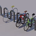 Colored Bicycles Parked at Black U Bicycle Rack on Green Grass and Concrete Pavement