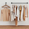 Stylish Wooden Clothes Hangers Holding Various Neutral Toned Sweaters And Shirts