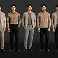 Group of Five Men in Various Stylish Casual Tops and Pants Against Black Background
