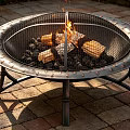 Outdoor Metal Fire Pit With Mesh Cover Burning Wood Logs On Brick Patio