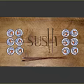 Assorted Sushi Rolls On Wooden Tray With Chopsticks And Engraved Sushi