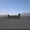Sturdy Metal Entrance Gate With Yellow Warning Stripes Pillars And Fencing On Gravel Ground
