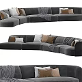 Large Curved Sectional Sofa With Gray Velvet Upholstery Multiple Decorative Cushions And Warm Throw Blanket