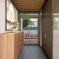 Modern Building Exterior With Large Glass Doors Wooden Deck And Green Trees Under Blue Sky