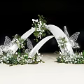 White Curved Wedding Arch With Butterfly Decorations White Flowers And Greenery