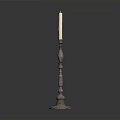 Metal Candle Holder With Decorative Column Base And Lit White Candle On Dark Background