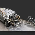 Burnt Car With Exposed Engine And Bicycle Parked Next To It 3d model