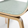 Modern Round Wooden Table With White Legs And Four Colored Upholstered Chairs