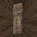 Golden Face Shaped Handle With Detailed Carved Design Mounted On Dark Wall And Radiant Light