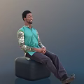 Man In Green Shirt With Camouflage Sleeves Sitting On Black Stool Hands Clasped Gray Background