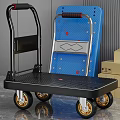 Black Platform Trolley With Gold Wheels Blue Board And Cardboard Boxes