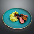 Duck Breast Slices on Blue Plate with Mashed Potatoes and Fruit Sauce