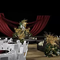 Elegant Banquet Hall with Red Curtains Stage Flower Arrangements Candles and White Chairs