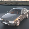 Gray Classic Sedan Parked On Smooth Surface With Trees In Background