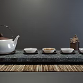 Traditional White Tea Set With Teapot Four Cups And Decorative Statue On Gray Background