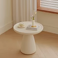 White Round Side Table with Coffee Cup Book and Flower Vase Near Window