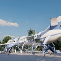 Outdoor Public Playground Featuring Airplane Shaped Structure With Slides Stairs And Green Trees