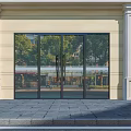 Modern Building Entrance With Reflective Glass Doors White Columns And Stone Pavement