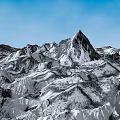 Rural Landscape Featuring Snowy Mountain Range With White Snow Covered Peaks Under Clear Blue Sky