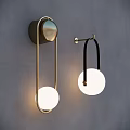 Modern Contemporary Wall Sconces With Gold And Black Metal Frames And Circular Illuminated Shades