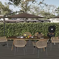 Rattan Outdoor Leisure Chairs In Garden Dining Area With Wooden Table Umbrella Grill And Greenery