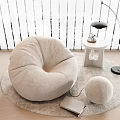 Cozy Plush Bean Bag Chair on Round Rug with Side Table Floor Lamp and Notebook
