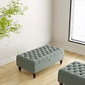 Light Green Tufted Ottoman with Wooden Legs near Window on Wooden Floor with Green Plant