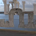 Intricately Carved Stone Architectural Elements By Seaside With Calm Water And Cloudy Sky