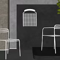 Sleek Metal Frame Leisure Chairs By Stone Wall With Plant And Shadows