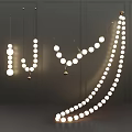 Illuminated Pendant Lights with Multiple Round Bulbs in Various Designs Hanging on Gray Background