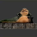Obese Green Game Movie Character With Orange Belly Sitting On Stone Platform