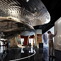 Modern Exhibition Hall Featuring Paintings Curved Structures Animal Motifs And Visitors On Illuminated Black Floor 3d model