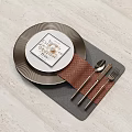 Cozy Dinnerware Set with Black Plate White Card Brown Woven Placemat and Silver Cutlery