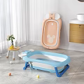 Blue Baby Bathtub With Foldable Pink Ear Shaped Backrest Colorful Balls Sink And Wooden Cabinet