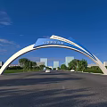 Taibai College Entrance Gate With Arch Structure Surrounded By Trees And Road Under Blue Sky