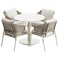 Modern White Wicker Table And Chair Set With Round Table And Four Cushioned Chairs