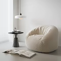 Fluffy Cozy Bean Bag Chair in White Room With Round Side Table and Soft Lighting