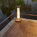 Outdoor Light on Wooden Deck with Railing Near Water and Natural Surroundings