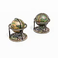 Decorative Vintage Globes on Ornate Metal Stands with Intricate Base Patterns