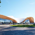 Modern Sales Office Building With Curved Roof Glass Curtain Walls And Green Lawn