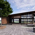 Modern Pavilion With Brick Structure Large Glass Windows Stone Pavement And Outdoor Benches