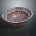 Intricately Carved Metallic Bowl With Detailed Patterns And Smooth Surface Design