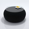 Round Black Woven Coffee Table with Glass Top White Plate and Yellow Fruits