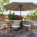 Outdoor Wicker Table And Chair Set With Large Umbrella And Green Plants
