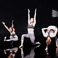 Three Women Performing Various Dance Poses In Activewear On Black Background With Floor Reflections