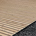 Natural Light Brown Wooden Flooring With Horizontal Planks And Adjacent Gravel