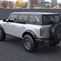 Silver Ford Bronco SUV With Large Off Road Tires And Modern Front Design