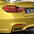 Yellow BMW M4 Coupe Parked In Garage Featuring White Brick Walls High Ceiling Tire Tracks
